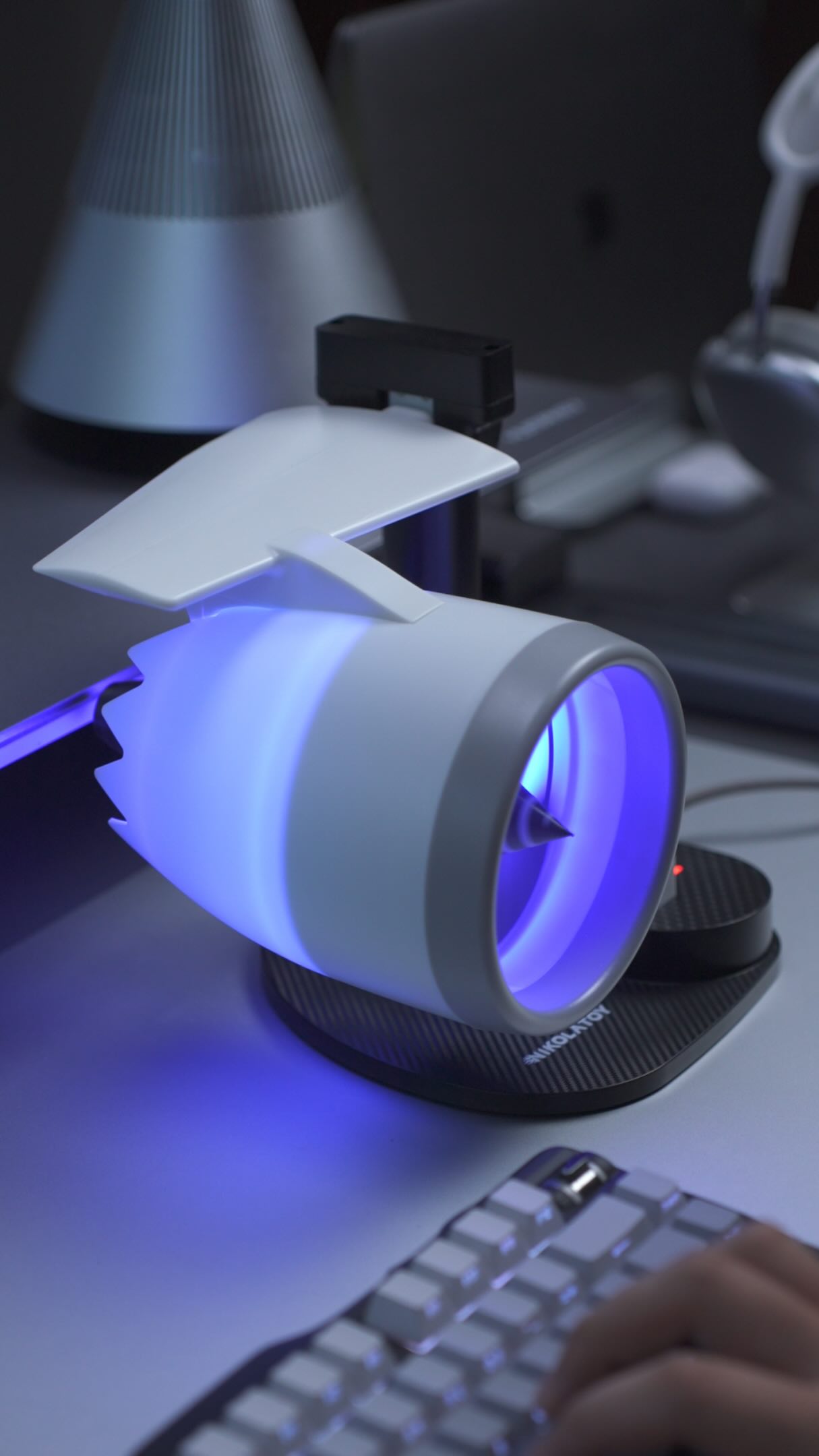 Aviation-inspired desk fan in a dark product setup